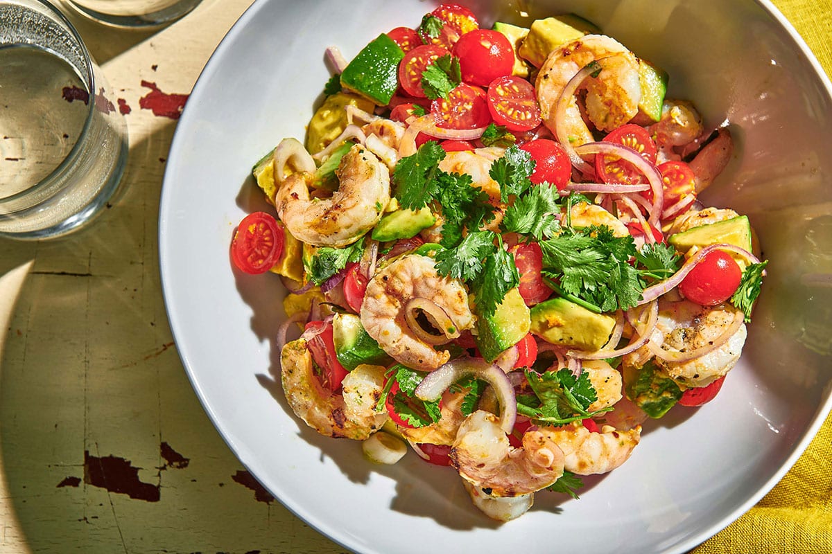 Grilled Shrimp Salad with Citrus Dressing in serving bowl on picnic table.