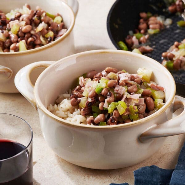 Hoppin' John in white bowls on table.