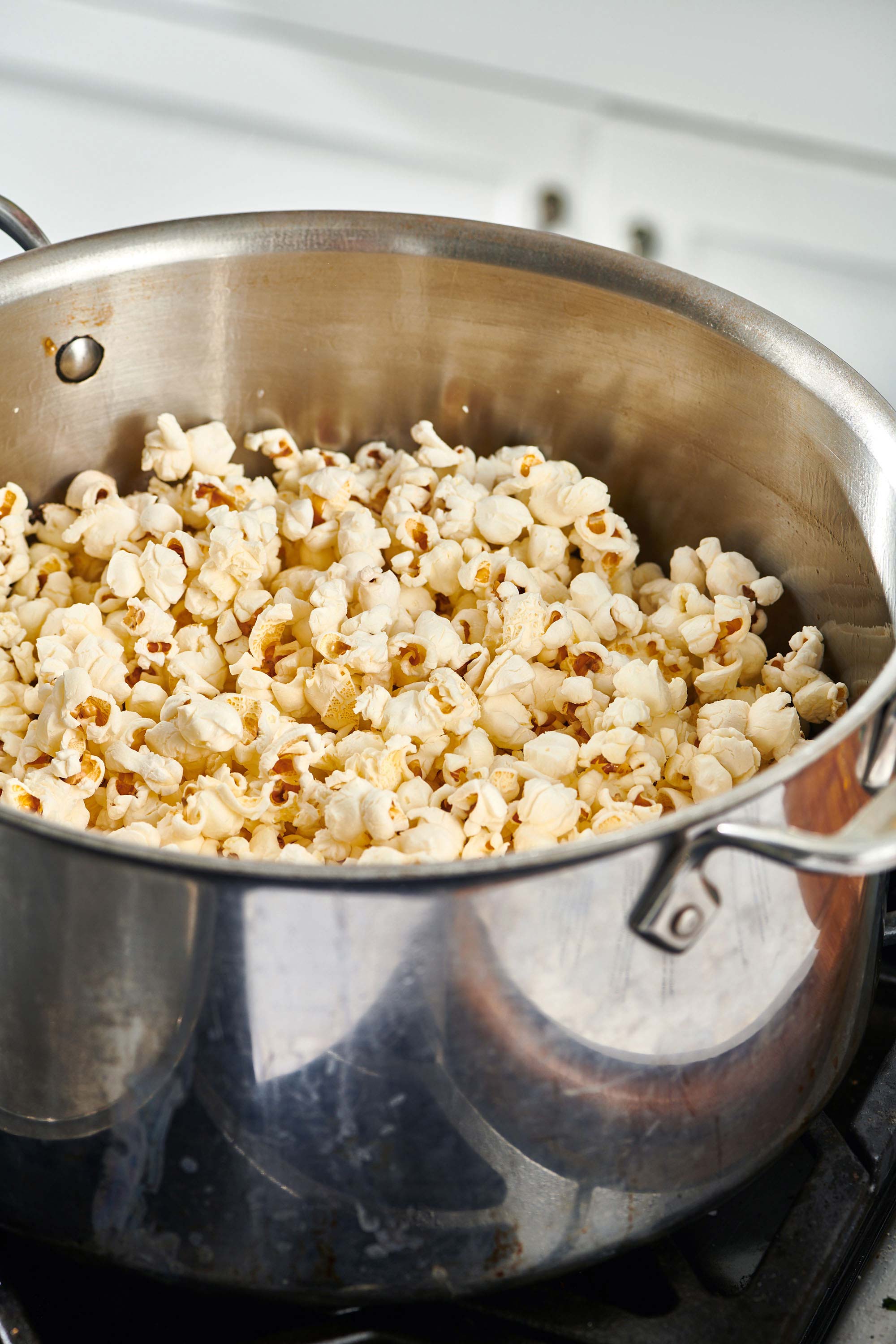 Popcorn in a pot on the stove.