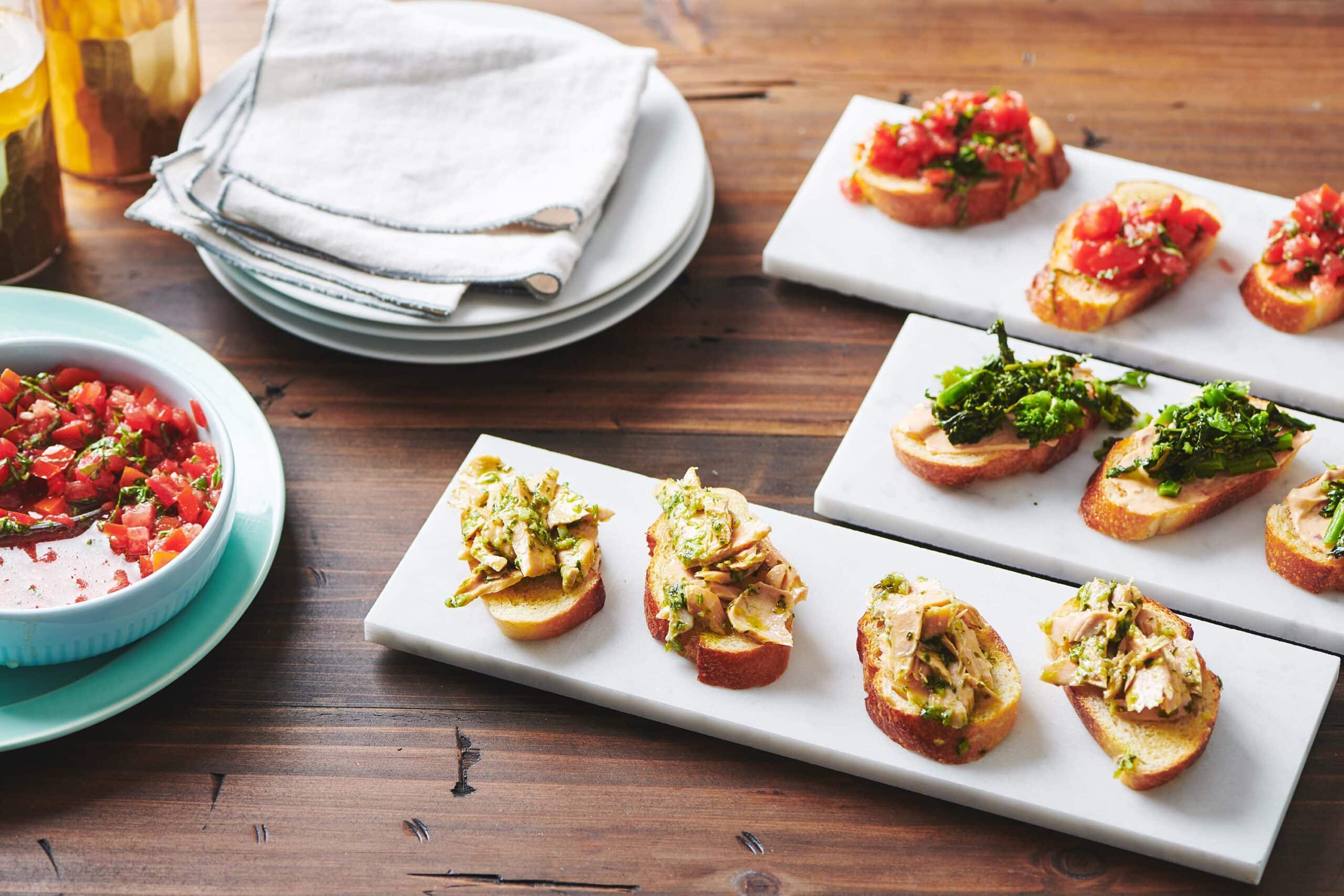 Lines of three different flavors of crostini.