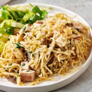 Turkey Tetrazzini and salad on a white plate.