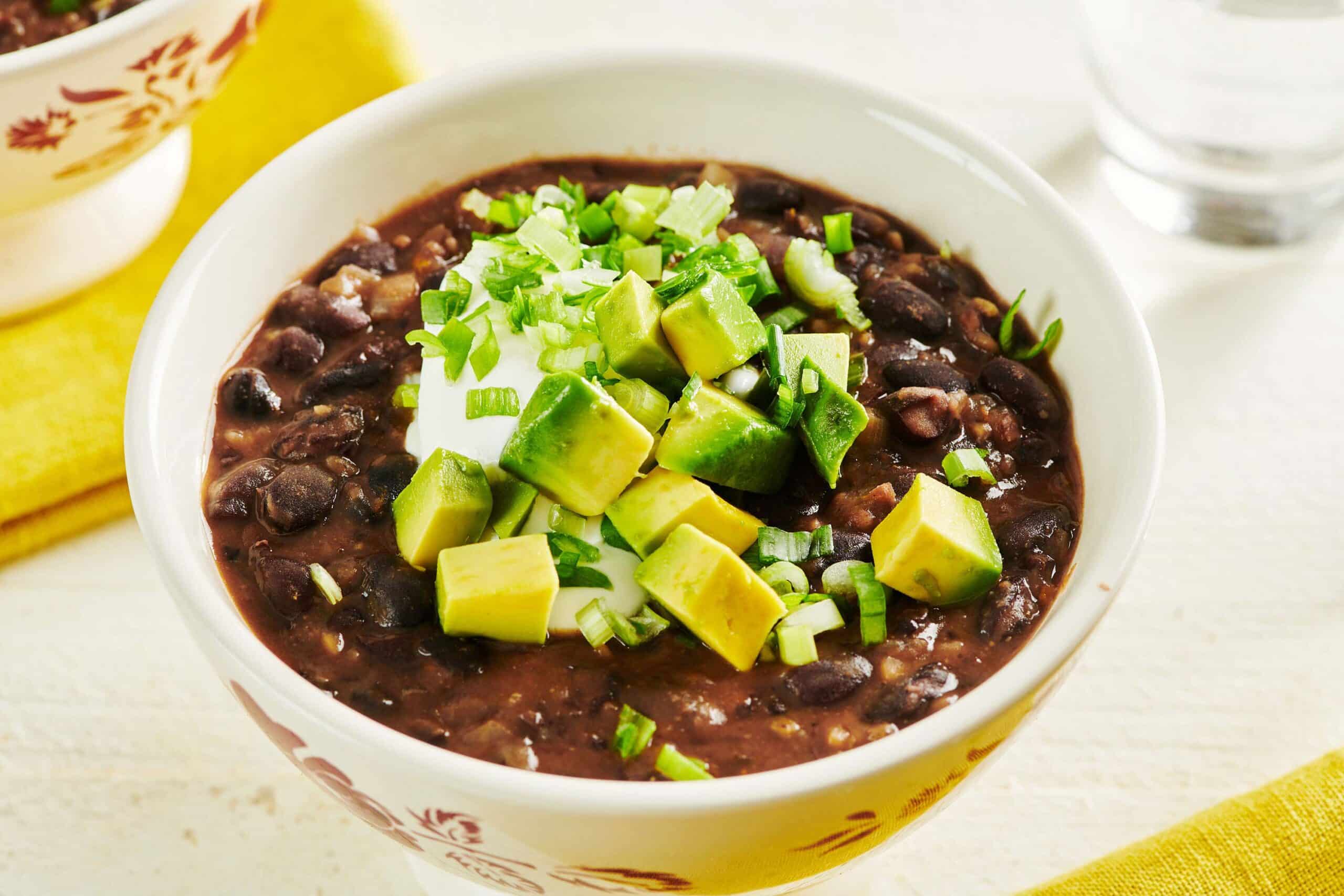 Bowl of Vegetarian Black Bean Soup topped with avocado.