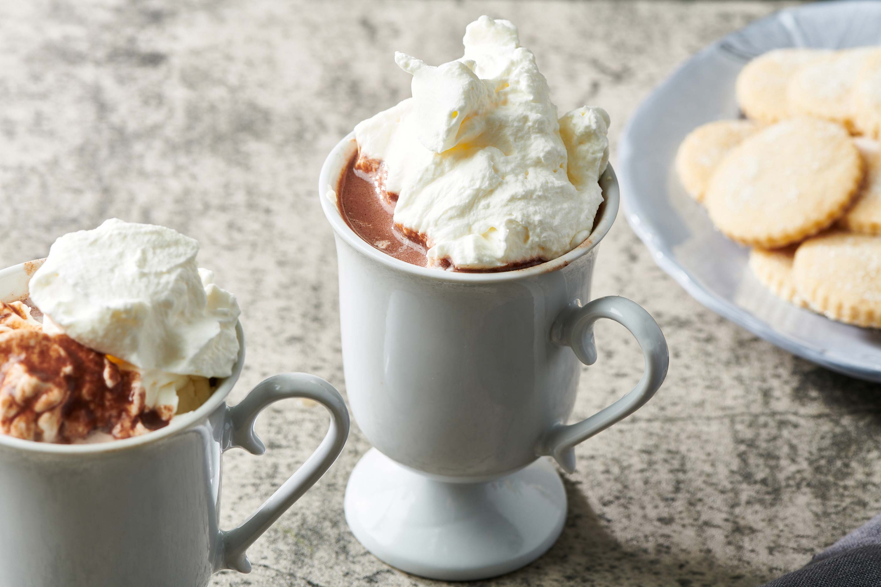 Small mug of Hot Chocolate topped with whipped cream.