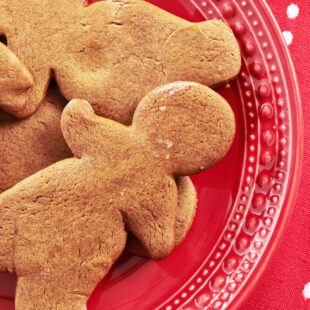 Gingerbread men on a red plate.
