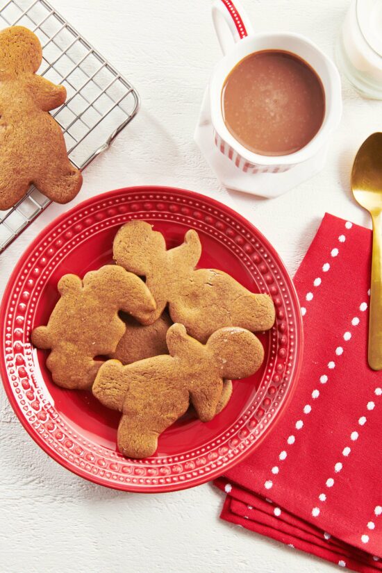 Four Gingerbread Cookies set on a red plate.