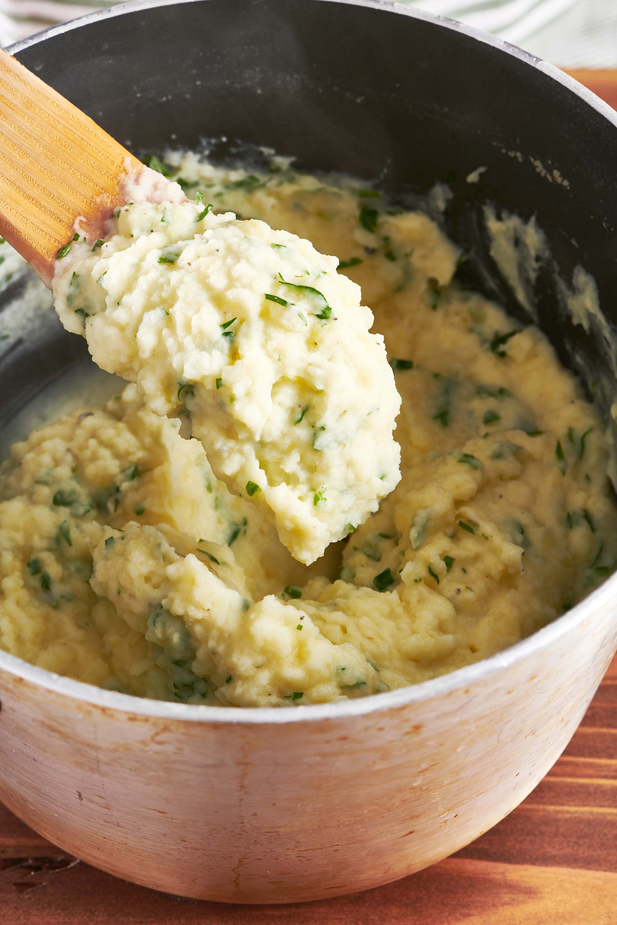 Herb Mashed Potatoes on a wooden serving spoon.