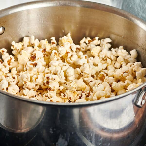Homemade popcorn in large pot on stove.