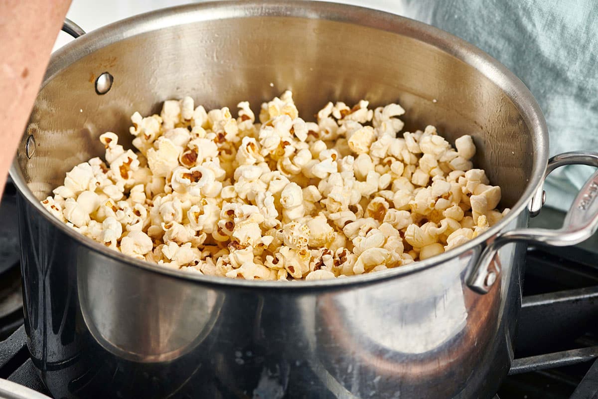 Homemade popcorn in large pot on stove.