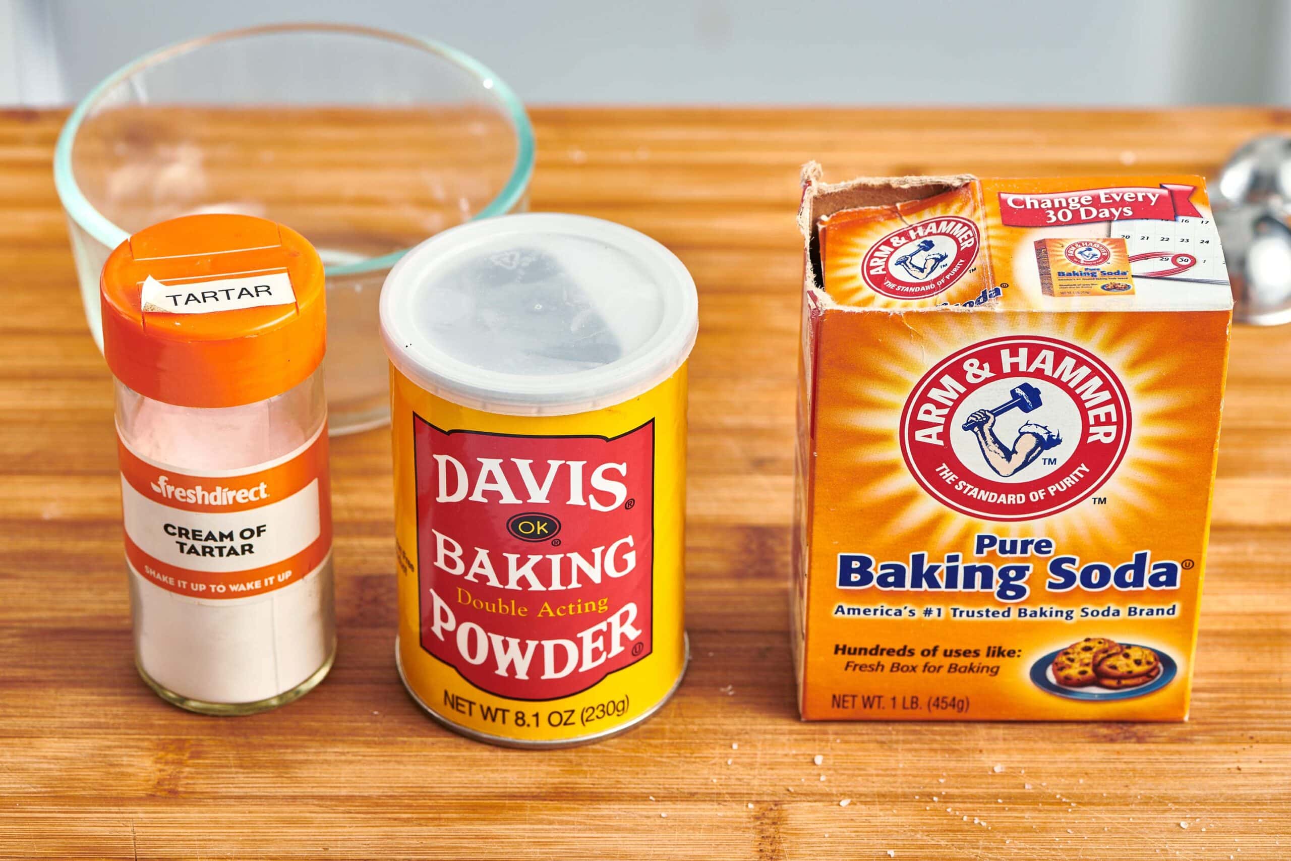 Cream of tartar, baking powder, and baking soda on a cutting board.