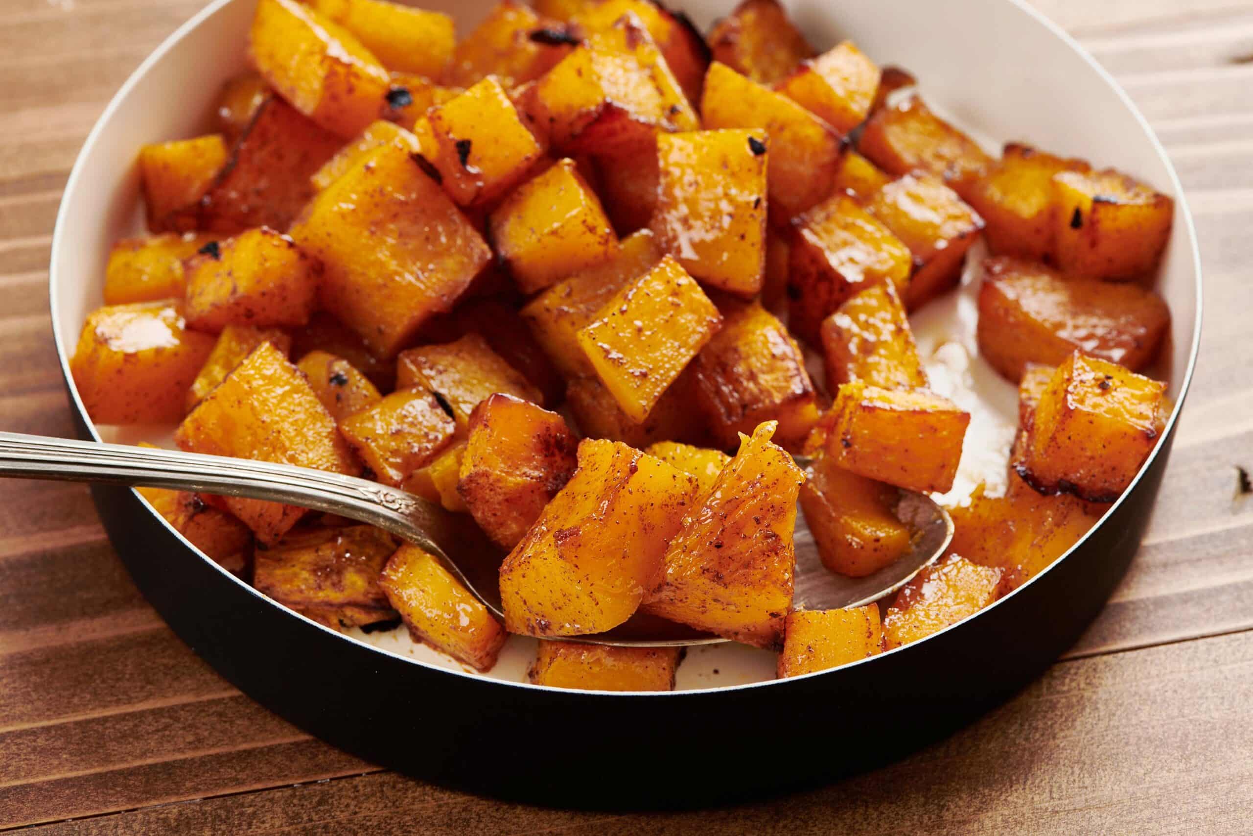 Maple Roasted Butternut Squash in serving dish with spoon.