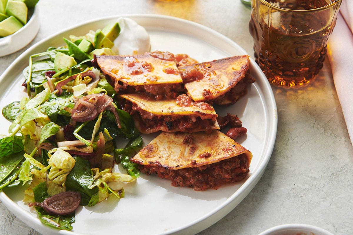Plate with chili cheese quesadillas and salad.