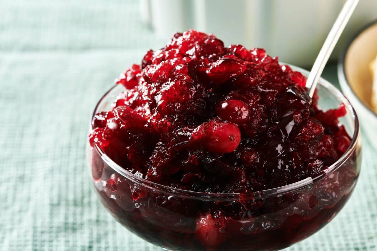 Glass bowl piled high with Cranberry Sauce.