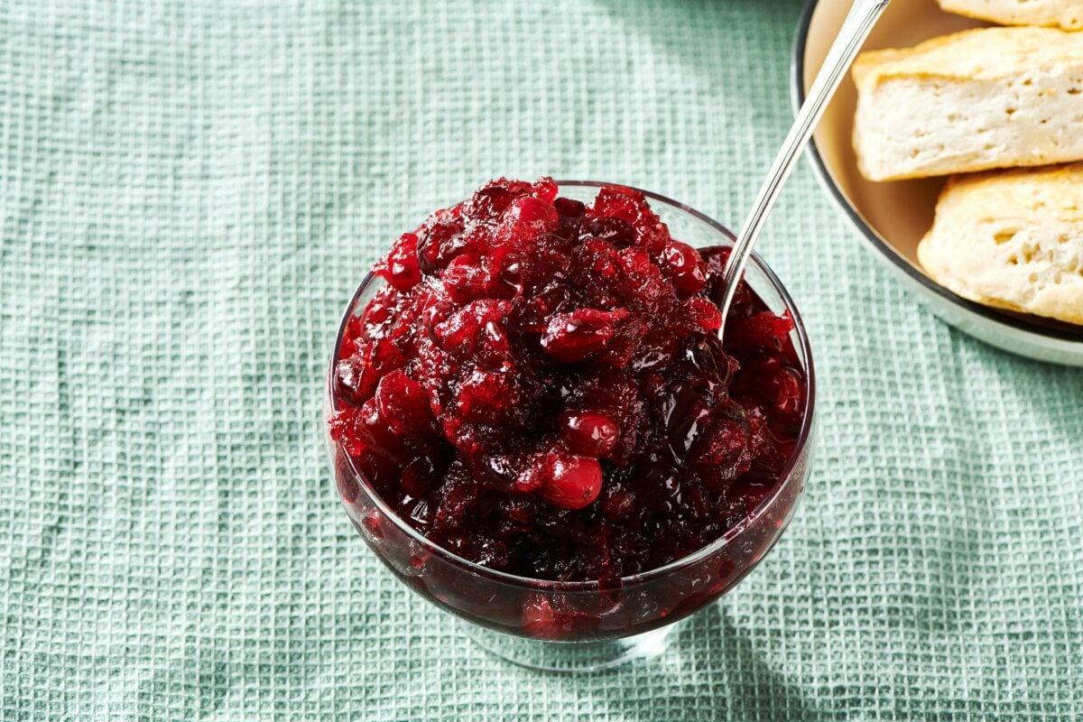 Spoon in a glass bowl of Cranberry Sauce.