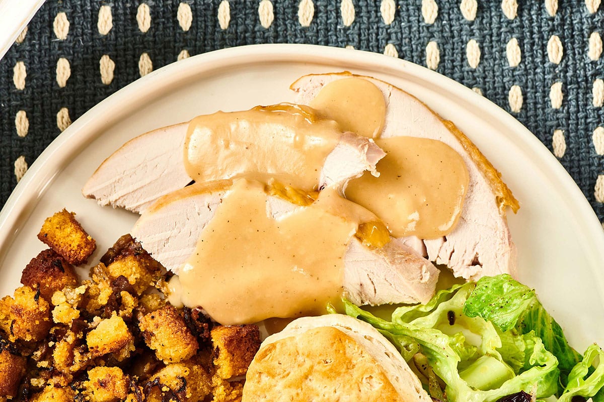 Slices of turkey topped with gravy.