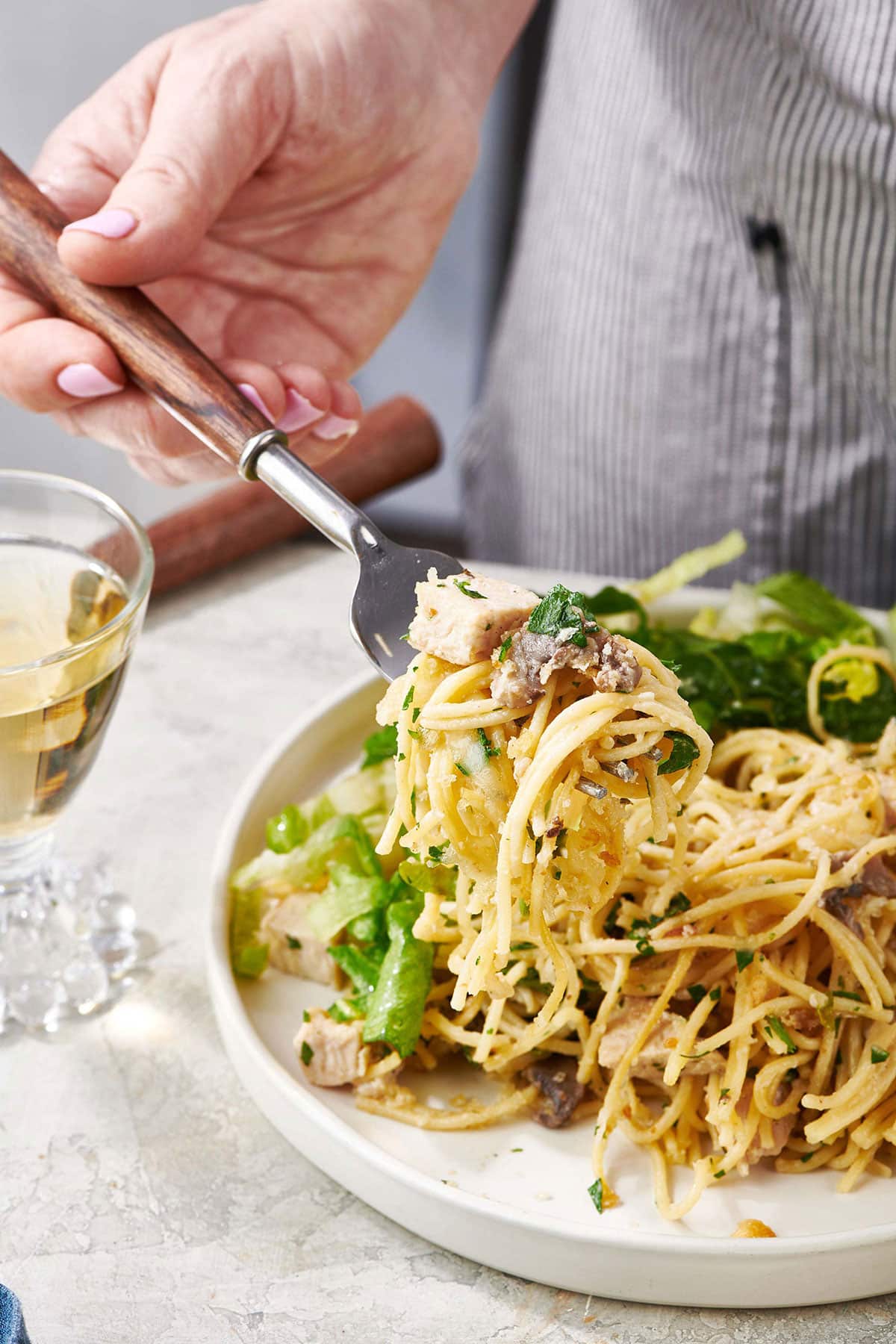Fork scooping Turkey Tetrazzini from a plate.