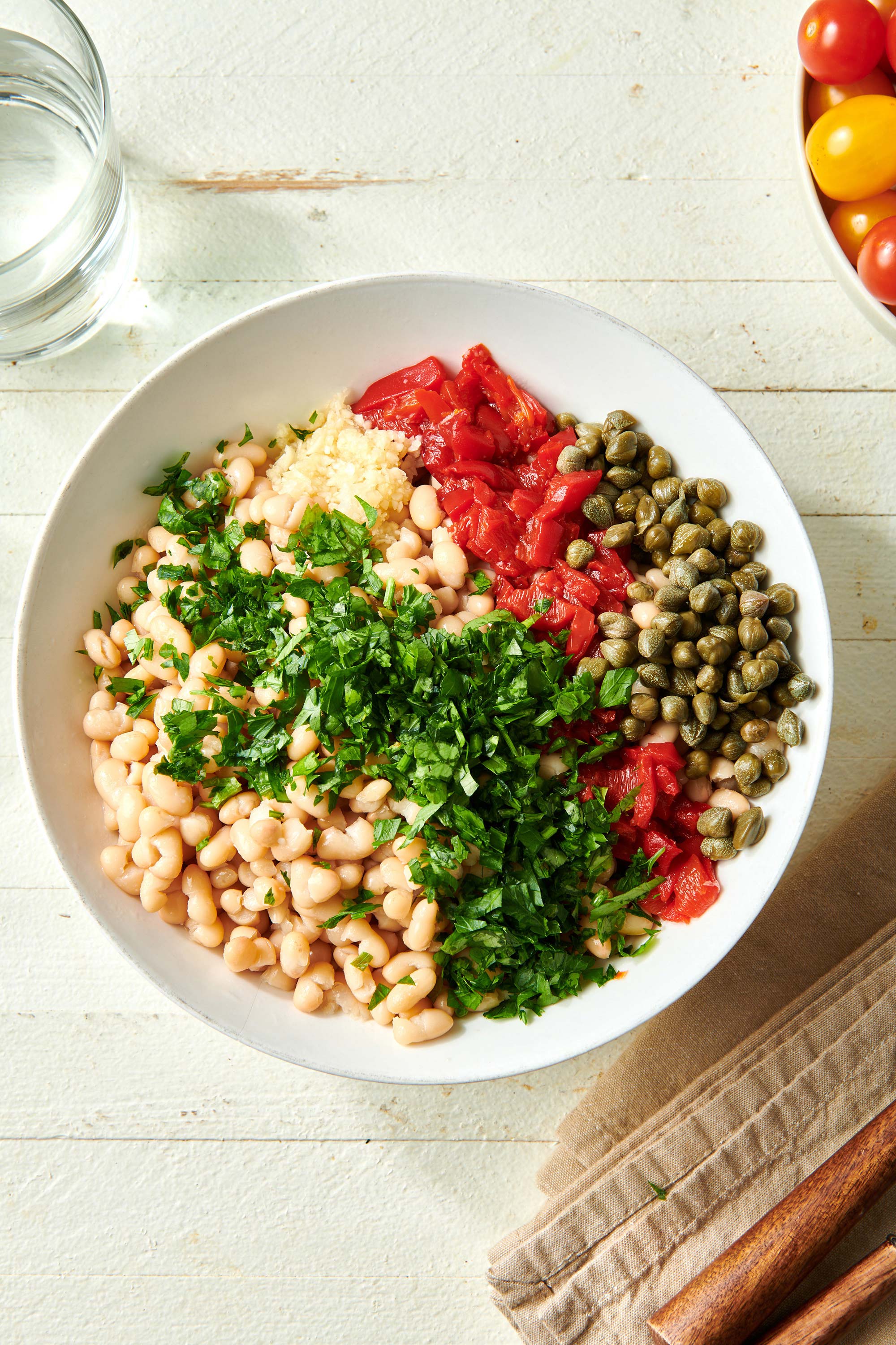 Bowl of unmixed White Bean Salad ingredients.