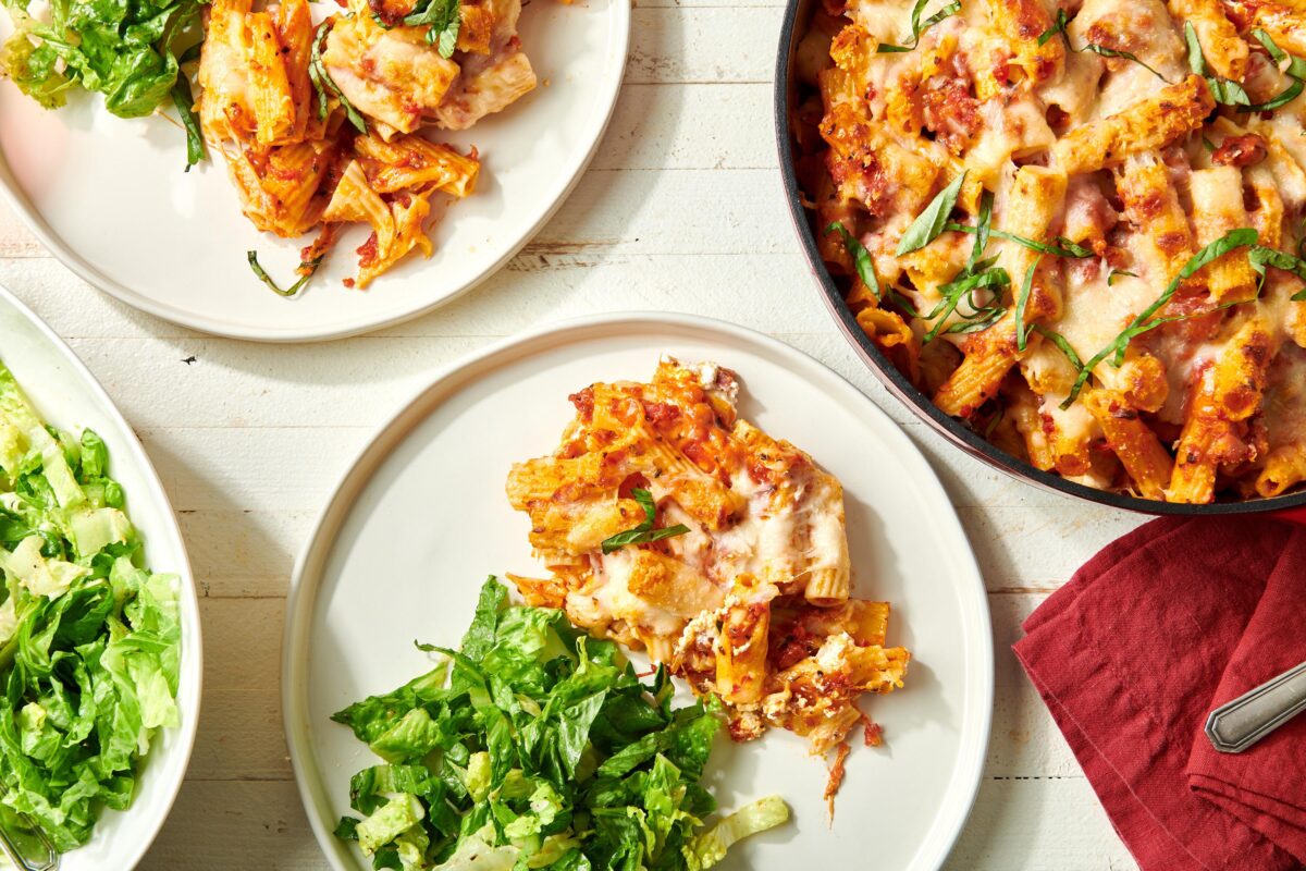 Baked Ziti in a skillet and on plates.