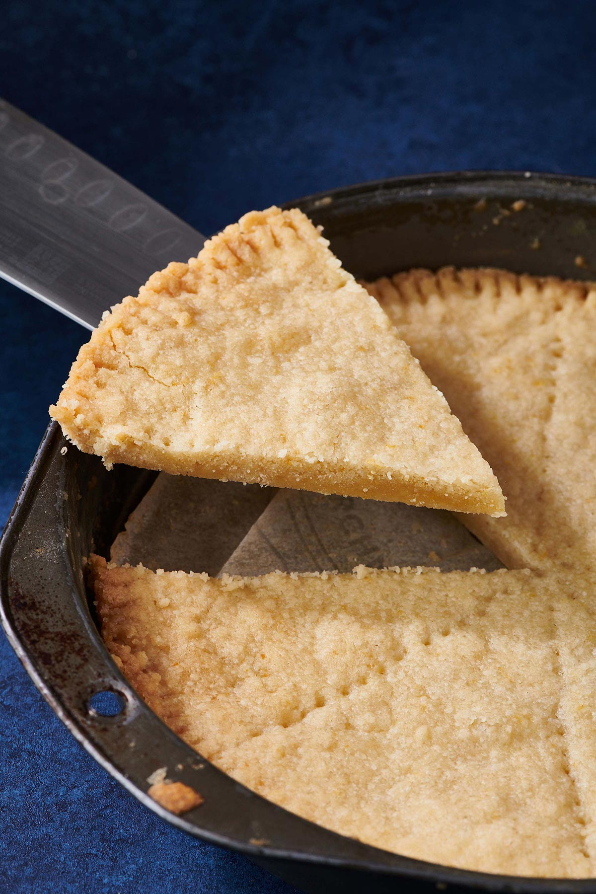 Knife grabbing a slice of shortbread cookie.