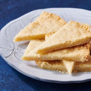 Shortbread Cookies stacked on white plate.