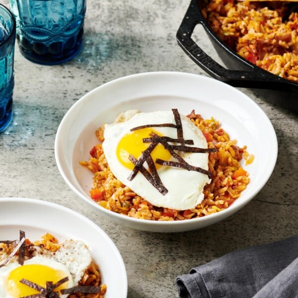Kimchi Fried Rice in bowls and in a skillet.