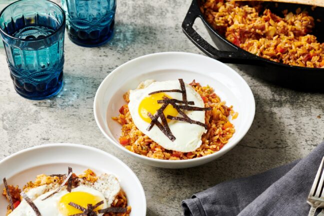 Kimchi Fried Rice in bowls and in a skillet.