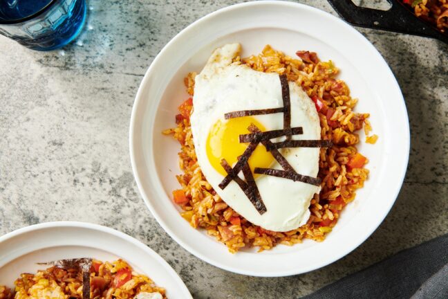 Over easy egg on a bed of Kimchi Fried Rice.