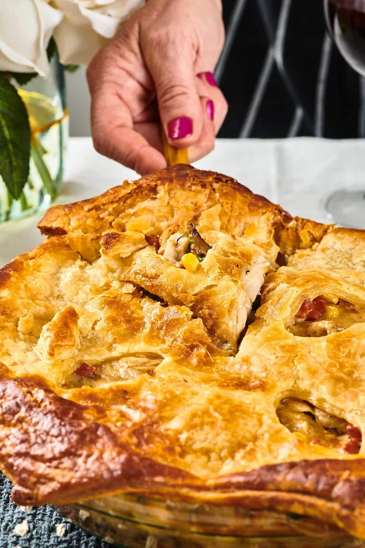 Woman using a spatula to grab a slice of Turkey Pot Pie.