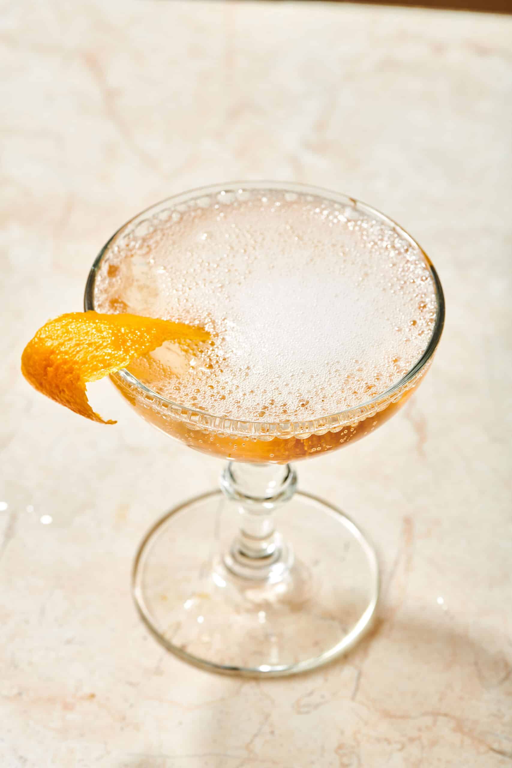 Bubbly French 75 with an orange peel.