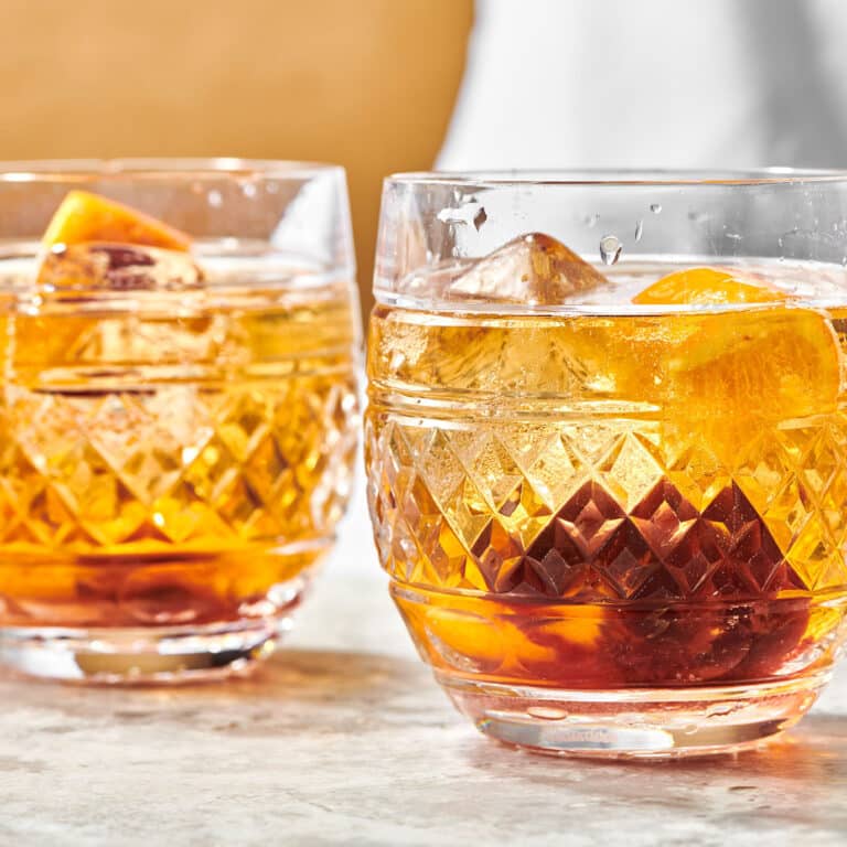 Two Old Fashioneds in rocks glasses.