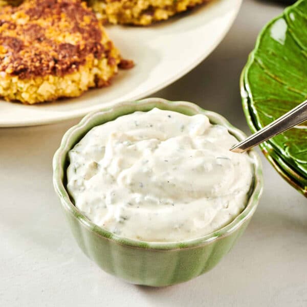 Spoon in a small green bowl of homemade tartar sauce.