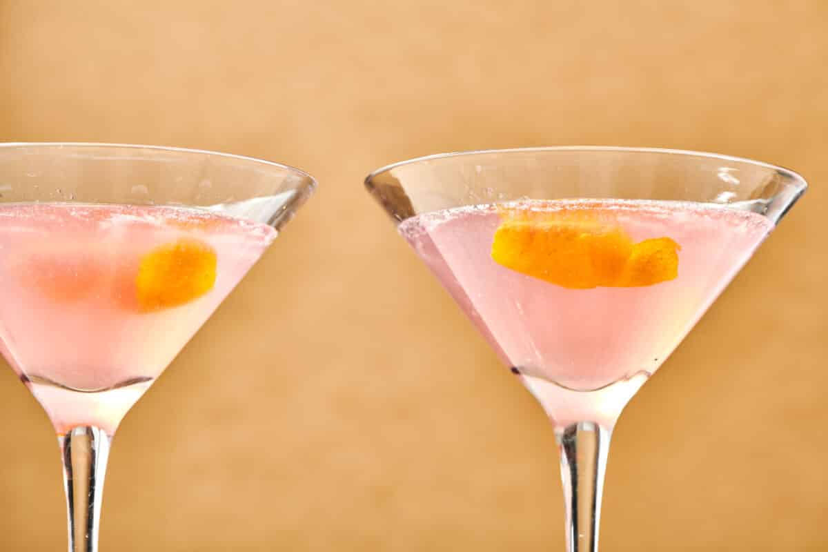Two Cosmo Cocktails in long-stemmed glasses.