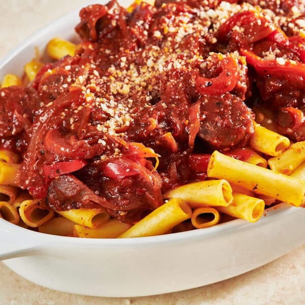 Sausage and Peppers Pasta in white serving dish.