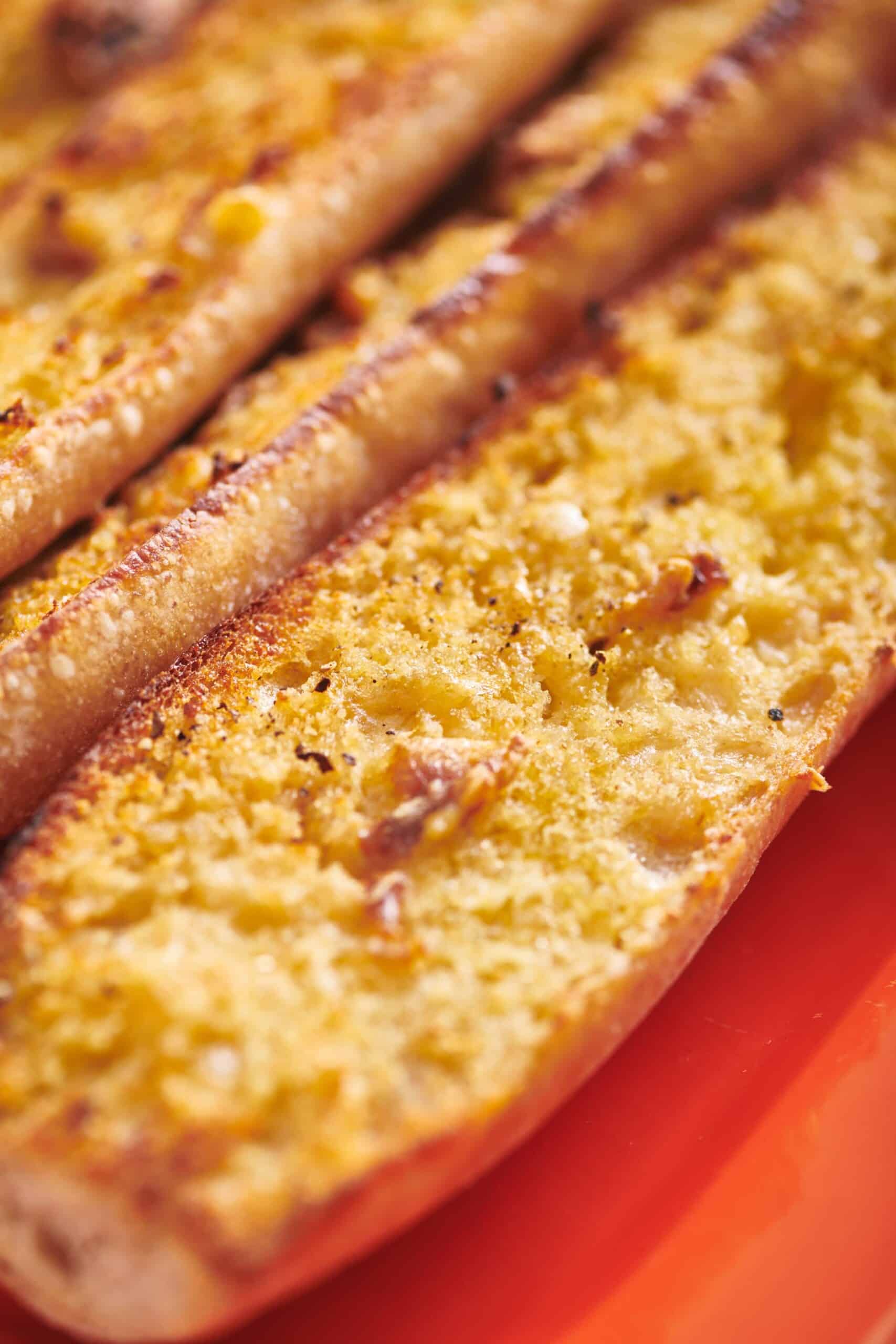 Long loafs of Vegan Garlic Bread with toasty edges.