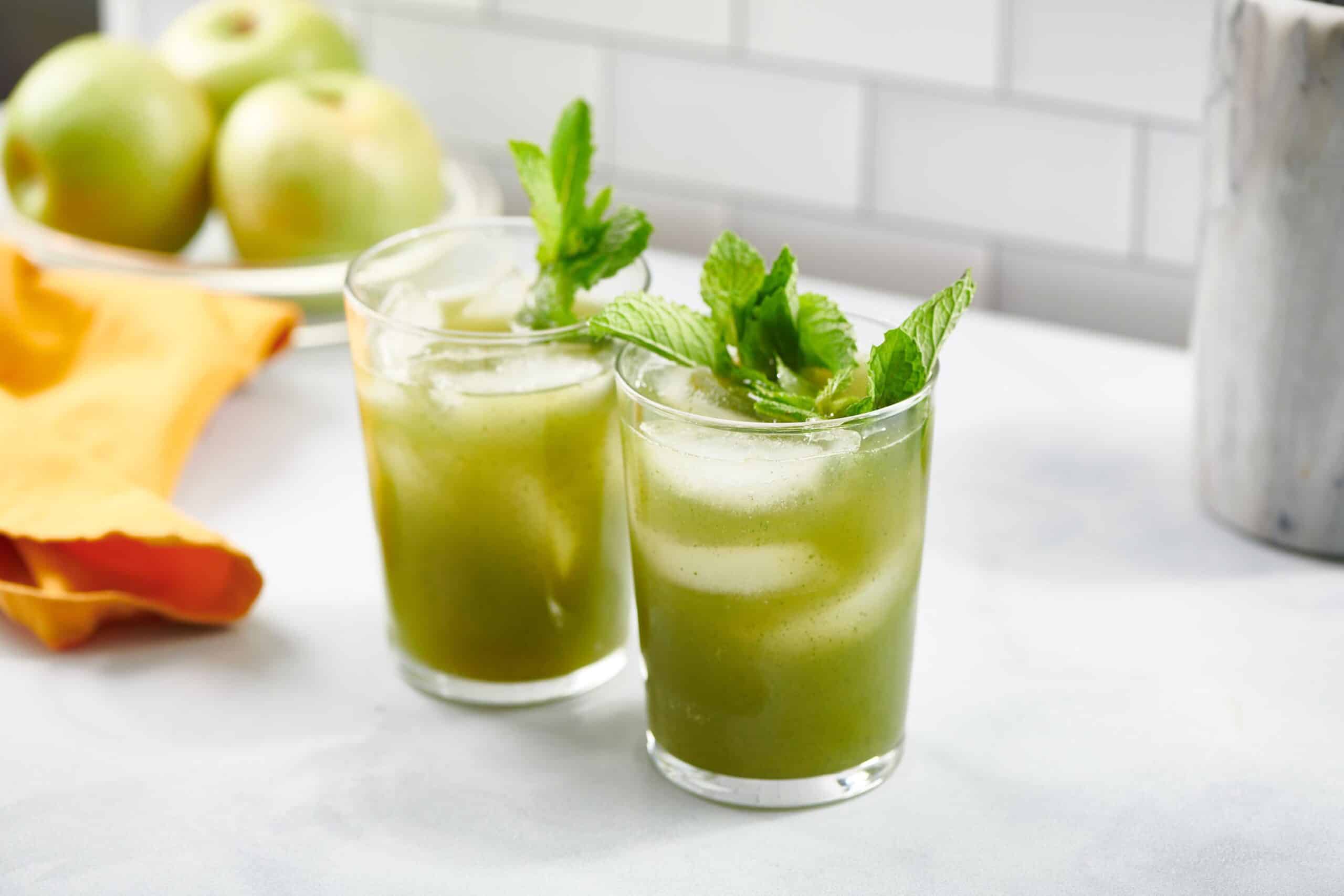 Two green Vodka Prosecco Cocktails in small glasses.