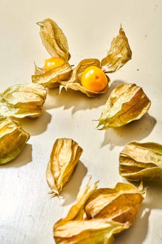 Golden berries on a white countertop.