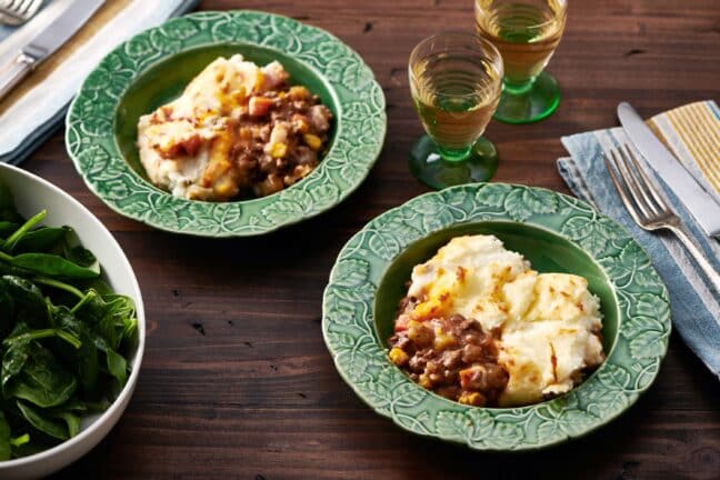 Two green-blue bowls of Cottage Pie.