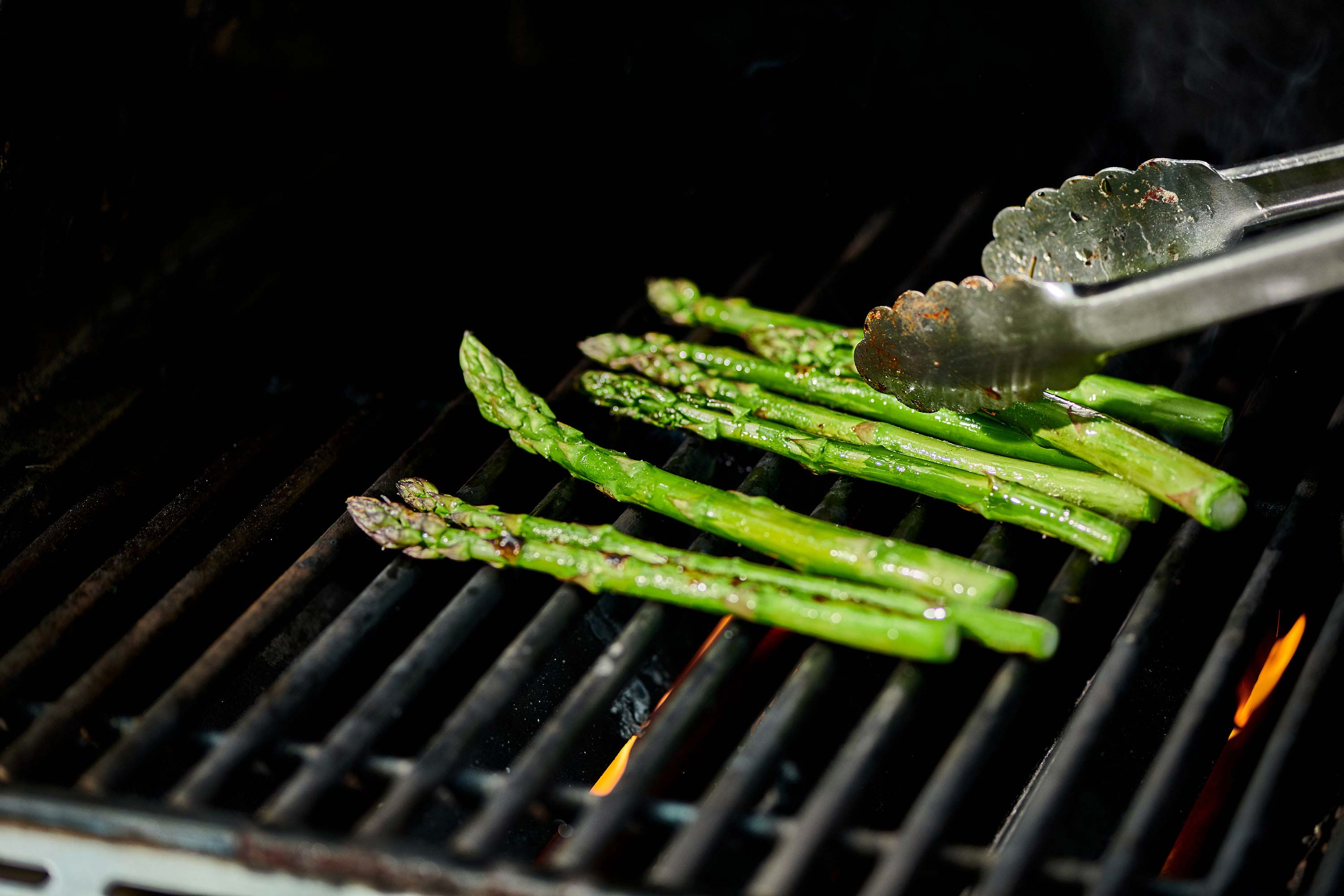 Grilling fresh asparagus spears.