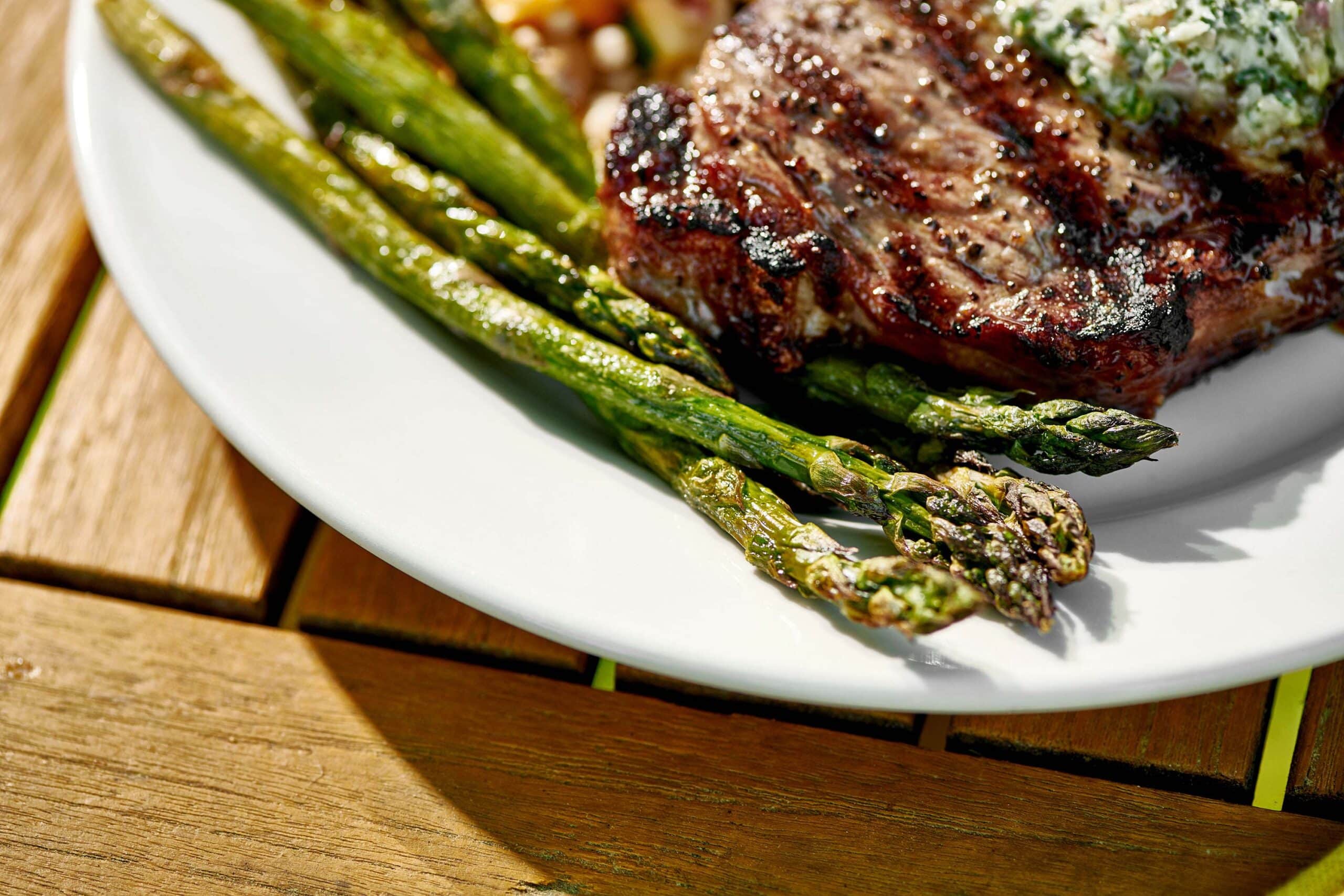 Grilled Asparagus and meat on a plate.