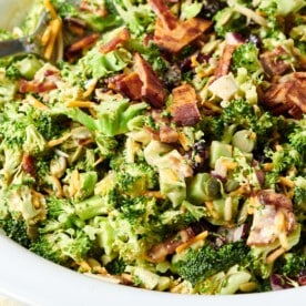 Bowl of Broccoli Salad topped with bacon and cheese.