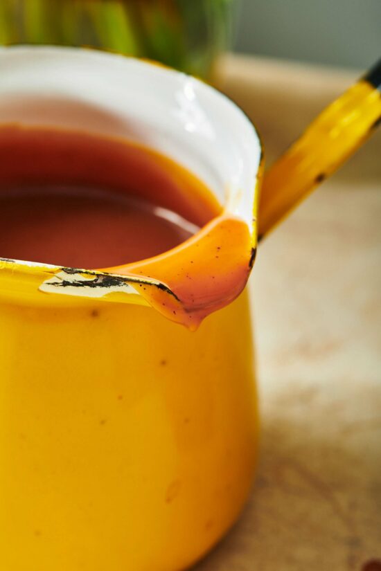 Spout of a pitcher covered in caramel sauce.