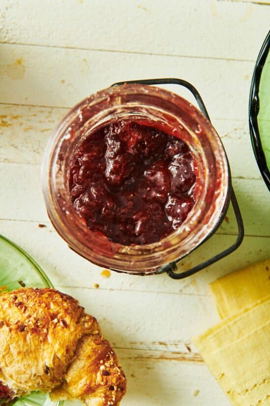 Open jar of strawberry jam.