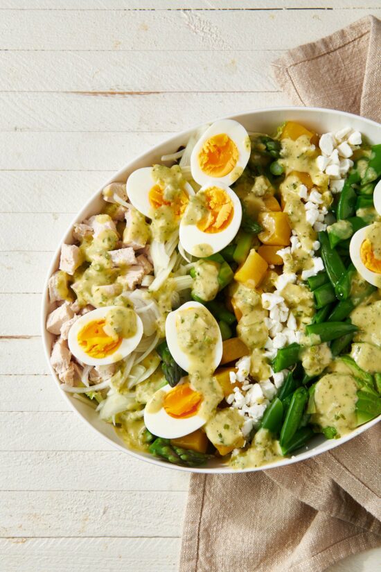 White bowl of Spring Cobb Salad with Scallion Dressing.