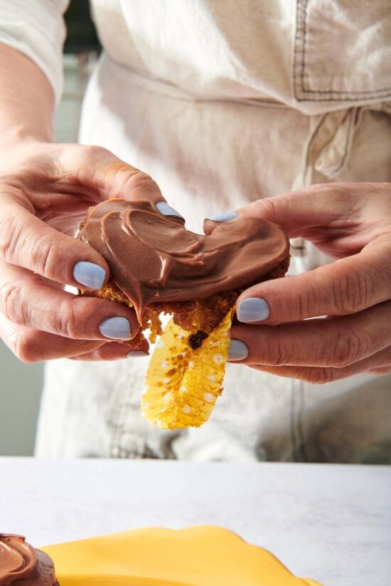 Woman tearing apart a Carrot Cake Cupcake.