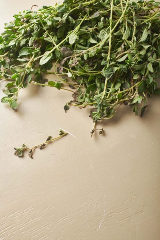 Oregano on a beige surface.