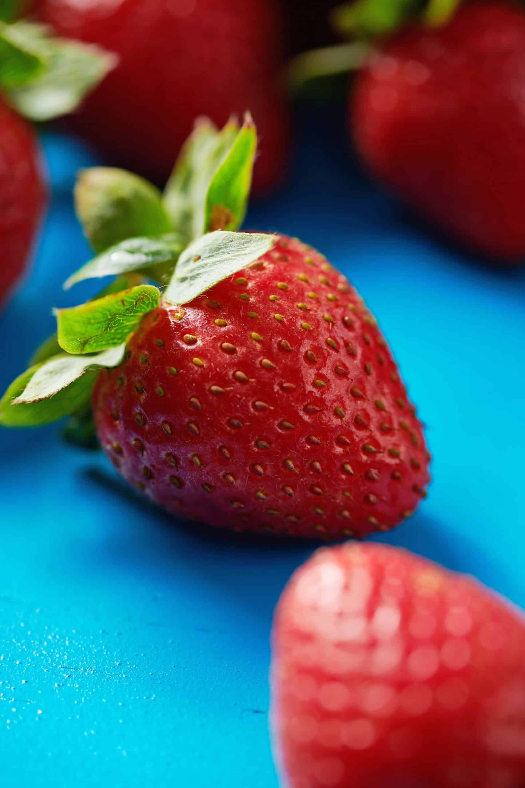 Fresh strawberries on blue table.