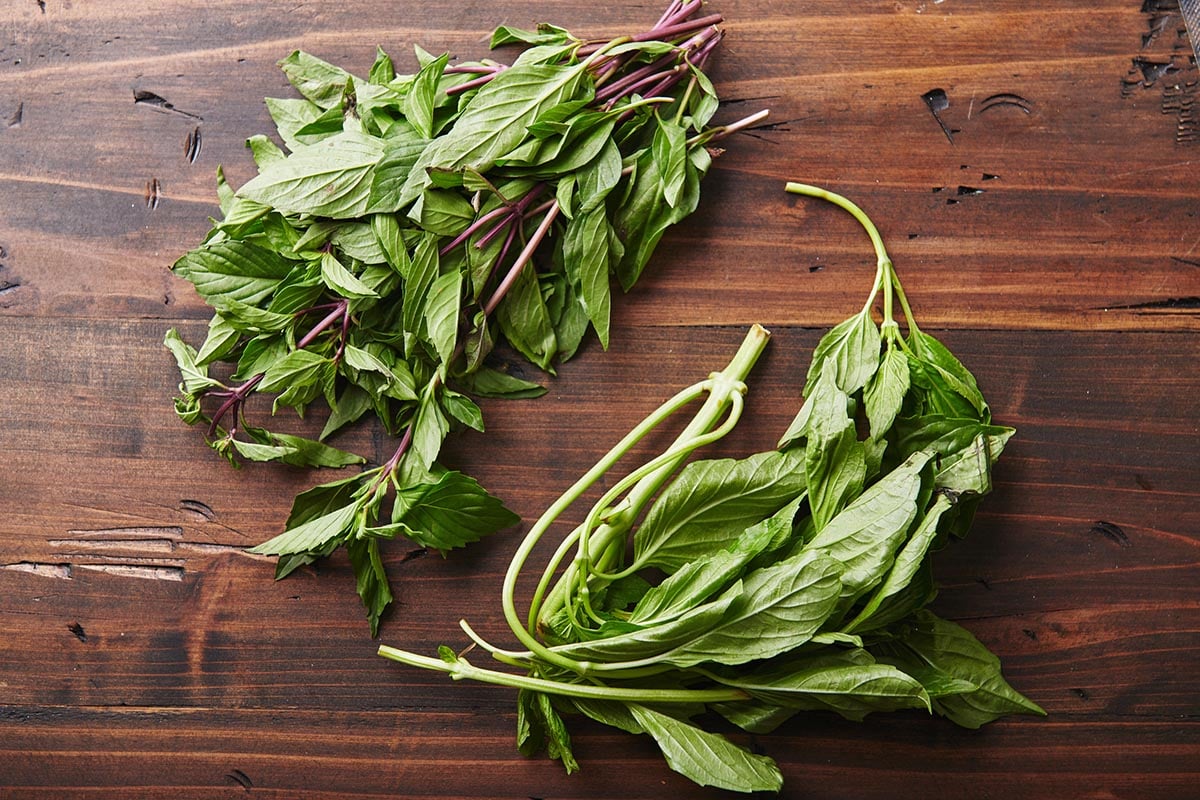 Fresh basil leaves on wood board.