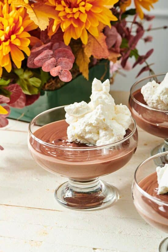 Large serving cups of Chocolate Pudding topped with whipped cream.