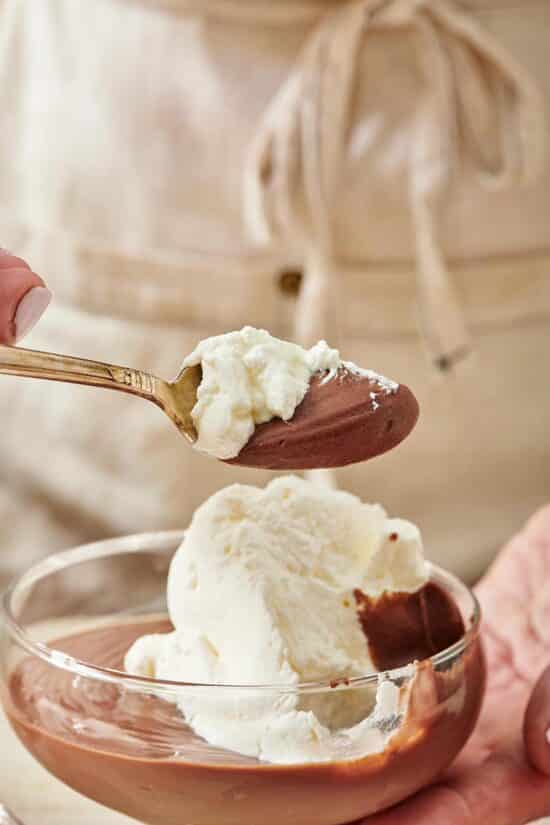 Spoon of Chocolate Pudding with whipped cream.