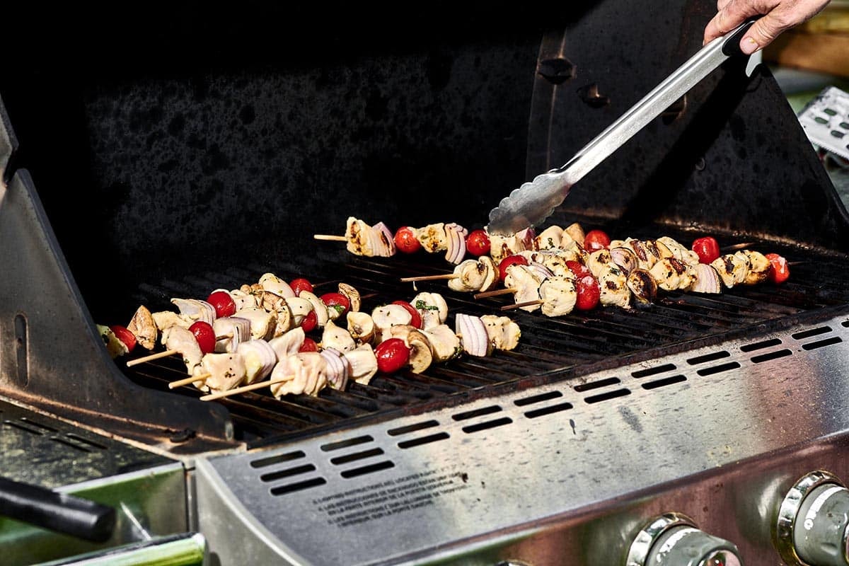 Grilling skewered Chicken Kabobs with Vegetables.