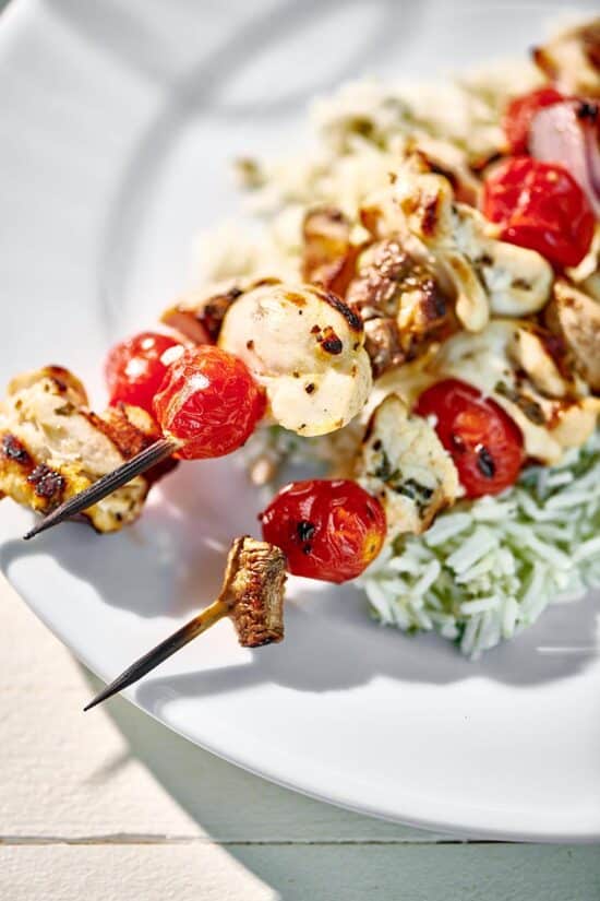 Grilled Chicken Kabobs with Vegetables on a bed of rice.